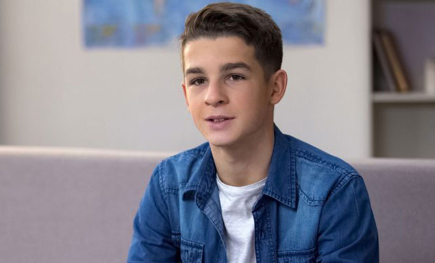 Young man sitting on a couch.